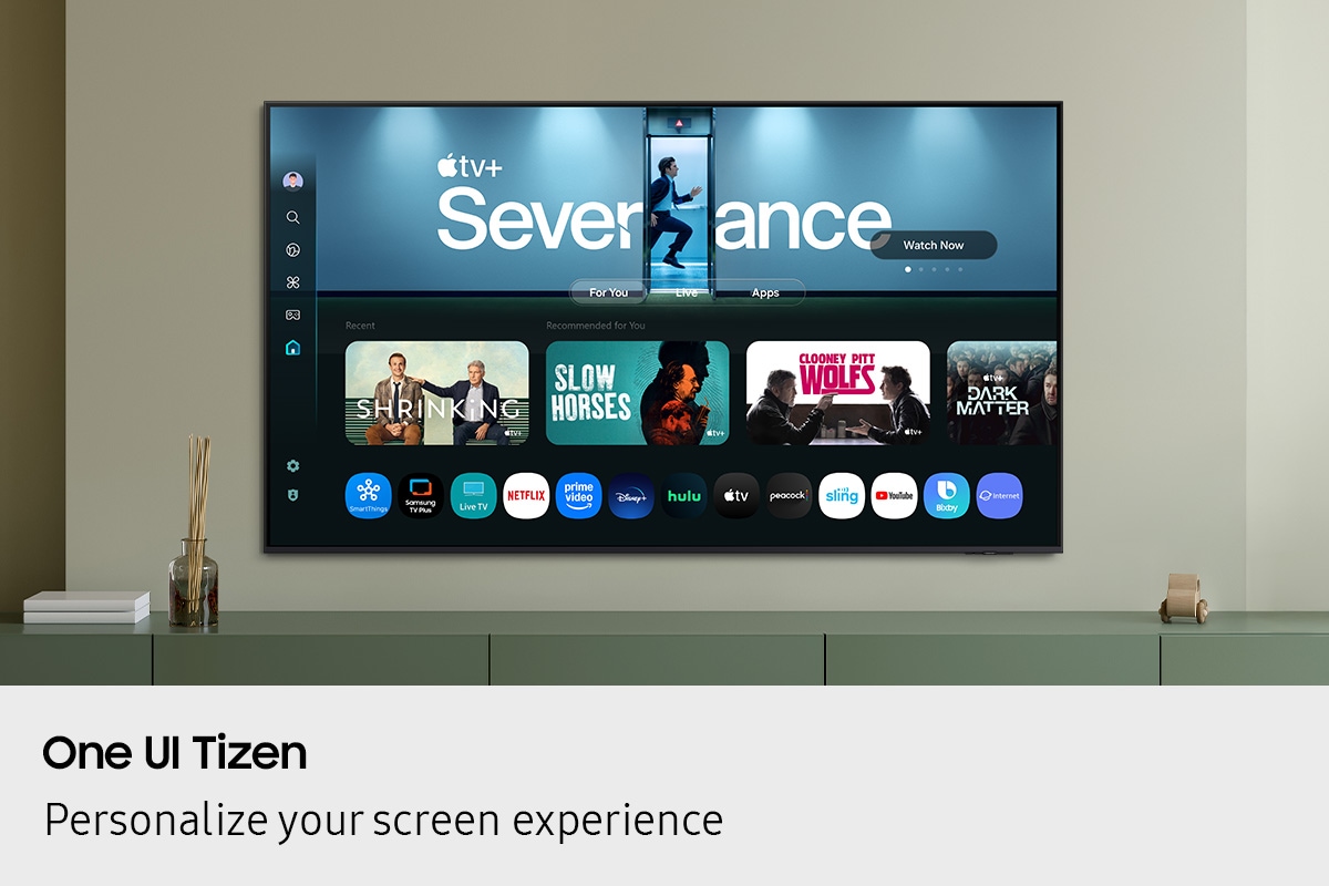 One UI Tizen’s home screen, with the various apps and services available, is displayed on a TV in a living room.