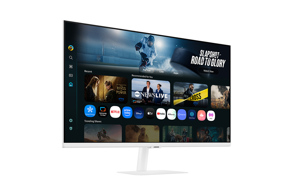 Front-left perspective of 32 inch Samsung Smart Monitor M7. Screen showing Smart TV Apps page with various content and apps lined up.