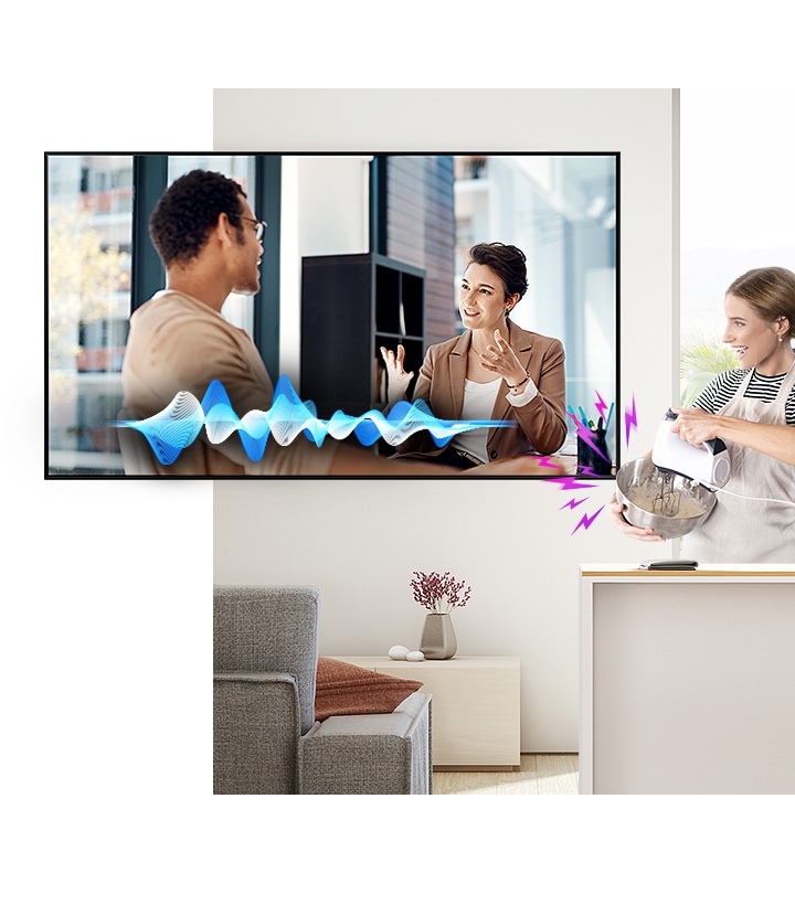 A Woman is Cooking While Watching TV. Despite the Noise Coming from the Mixer, the Active Voice Amplifier Technology Makes It Easy to Hear TV Conversations