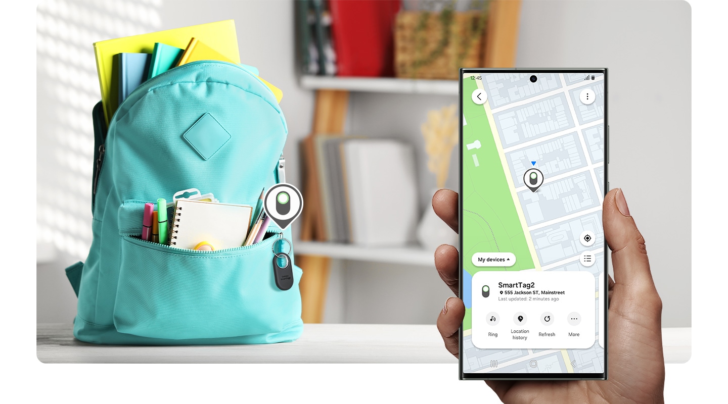 In the background, a child's backpack in a child's room is placed on a table with a Galaxy SmartTag2 device tagged as a keychain. Hovering above the device is the SmartTag2 icon. In the foreground, a hand holding a Galaxy smartphone device shows the map location of the Galaxy SmartTag2 device on SmartThings Find.