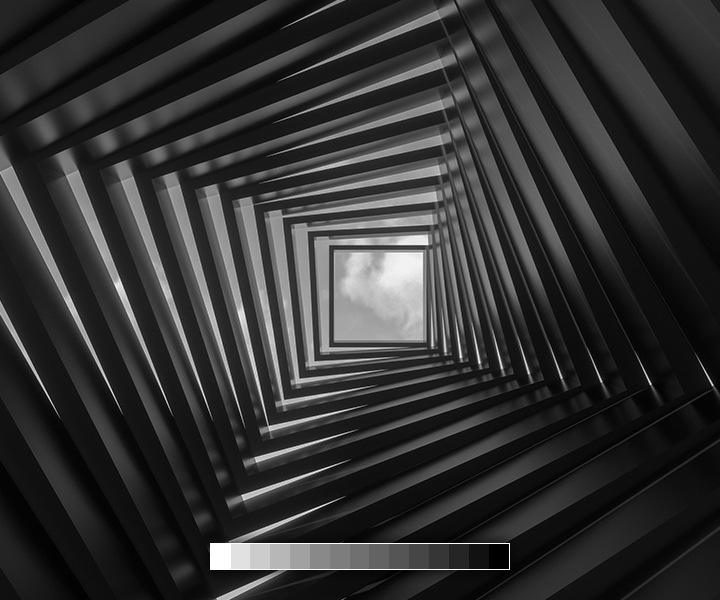A building’s architecture is shown with the point of view pointing up towards a cloudy sky with a grayscale chart on the bottom, indicating The Wall presents linear and accurate grayscale without distortion.