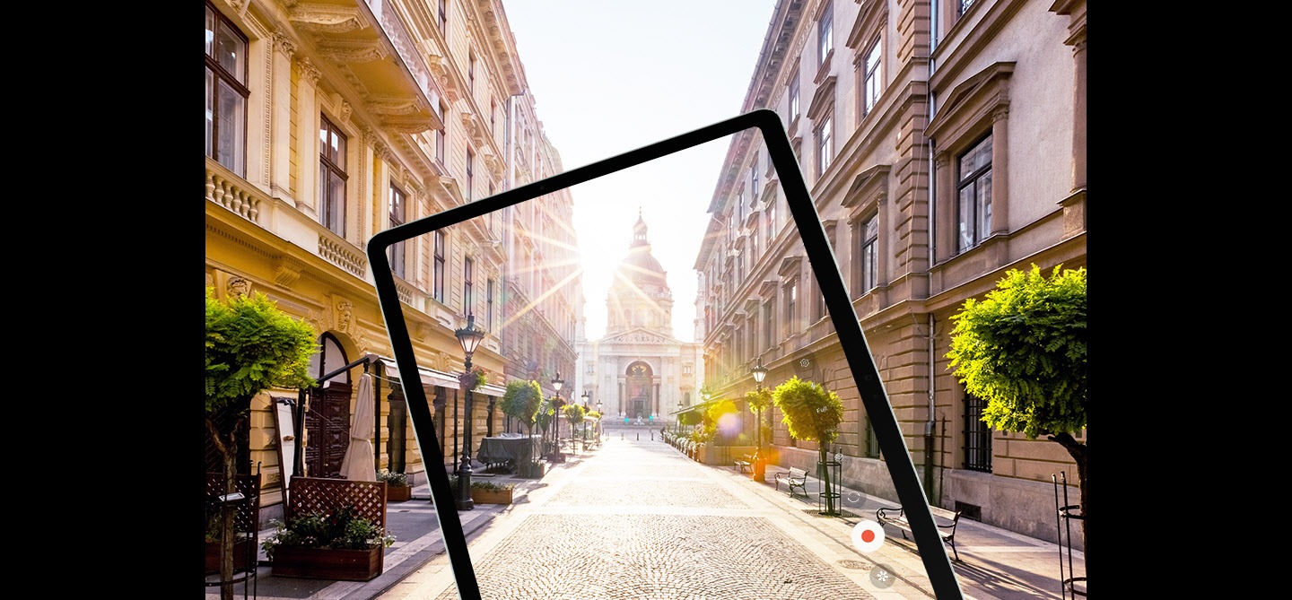 Galaxy Tab S9 FE+ displaying at full screen rays of sunlight over a city street captured by its camera with reduced glare to show a clearer image thanks to Vision Booster.