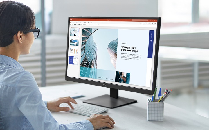 A person is working on a document with the Essential Monitor S3.