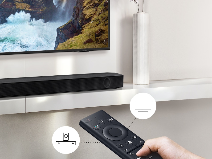 A user controls both soundbar and TV functions with Samsung TV remote.