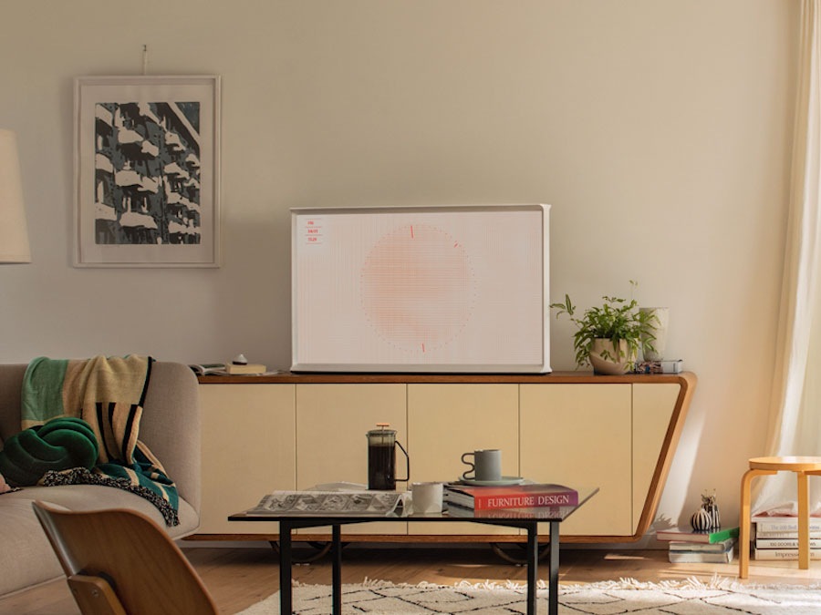 The Serif in various Ambient Modes on top of a cabinet, next to a woman reading a book, on a Stand and on top of a shelf.