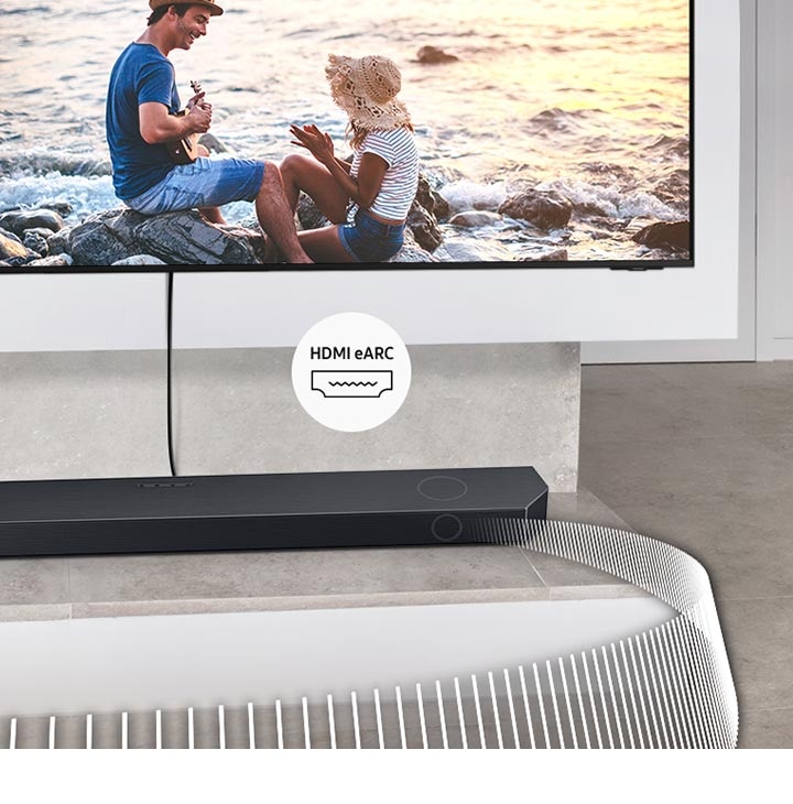 Soundbar přehrává zvukové vlny z televizoru připojeného kabelem. Přiložený štítek označuje HDMI eARC.