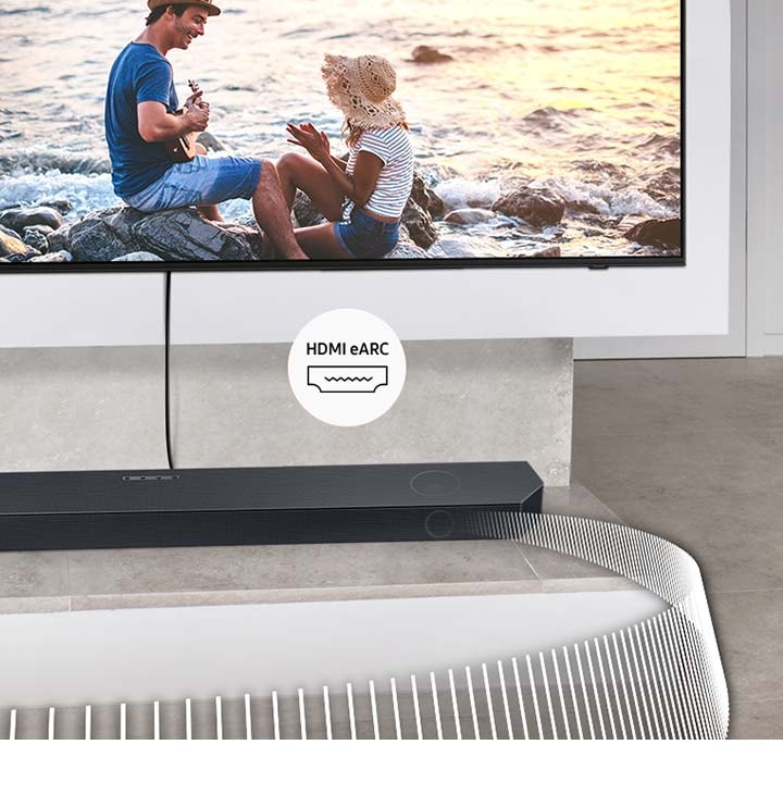 Soundbar přehrává zvukové vlny z televizoru připojeného kabelem. Přiložený štítek označuje HDMI eARC.