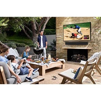 A family is having a meal in front of The Terrace, tv for outside patio