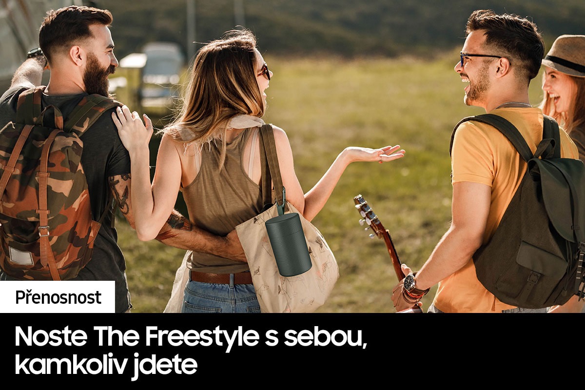 People are at a wide outdoor area in casual clothing chatting with eachother. The Freestyle Case is hanging on the woman's bag.