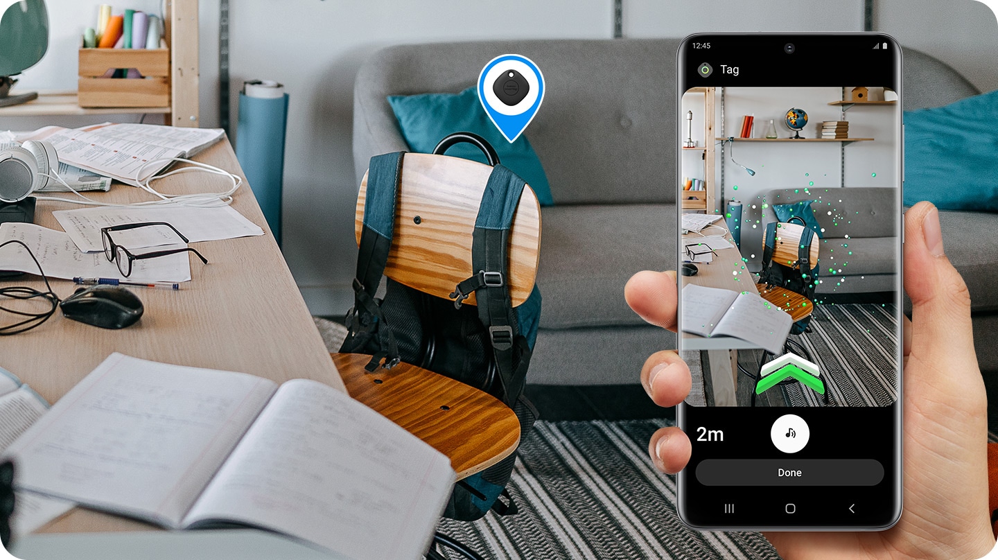 The user is holding the mobile following the way to the destination, where the green AR visual is seen through SmartThings app.