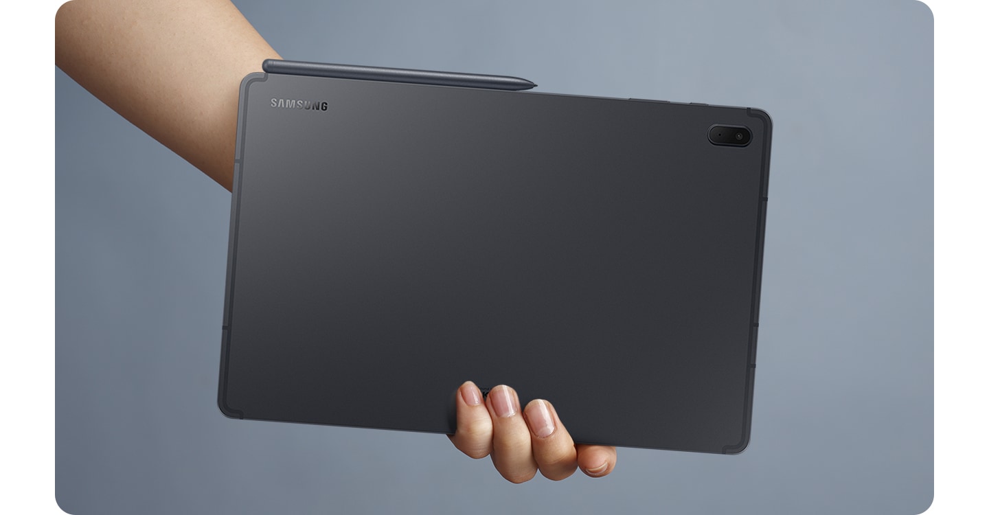 The back of a black Galaxy Tab S7 FE faces forward and an S Pen is attached conveniently to the side by magnet.