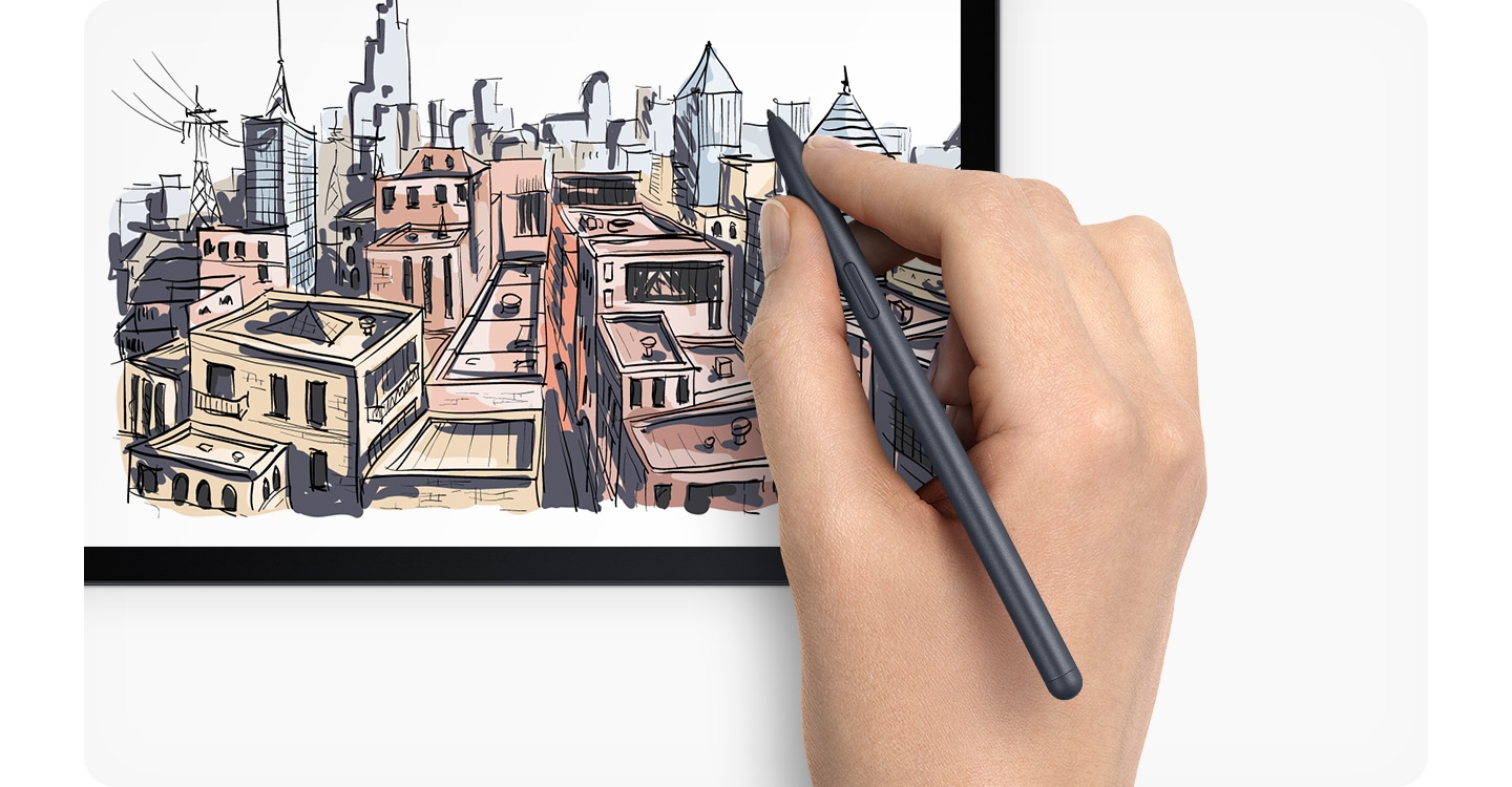 A detailed cityscape with buildings in red, yellow and grey is being drawn on a Galaxy Tab S7 FE with an S Pen in a right hand.