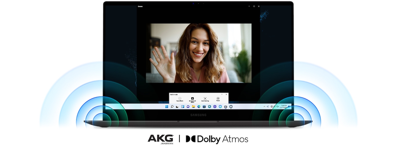 A Galaxy Book2 Pro 360 is facing the front. In the center of the screen, a woman is waving her hand during a video call. Powerful sound is coming out from the speakers on the bottom corners of the PC. Below the PC are two logos for AKG by Harman® and Dolby Atmos.