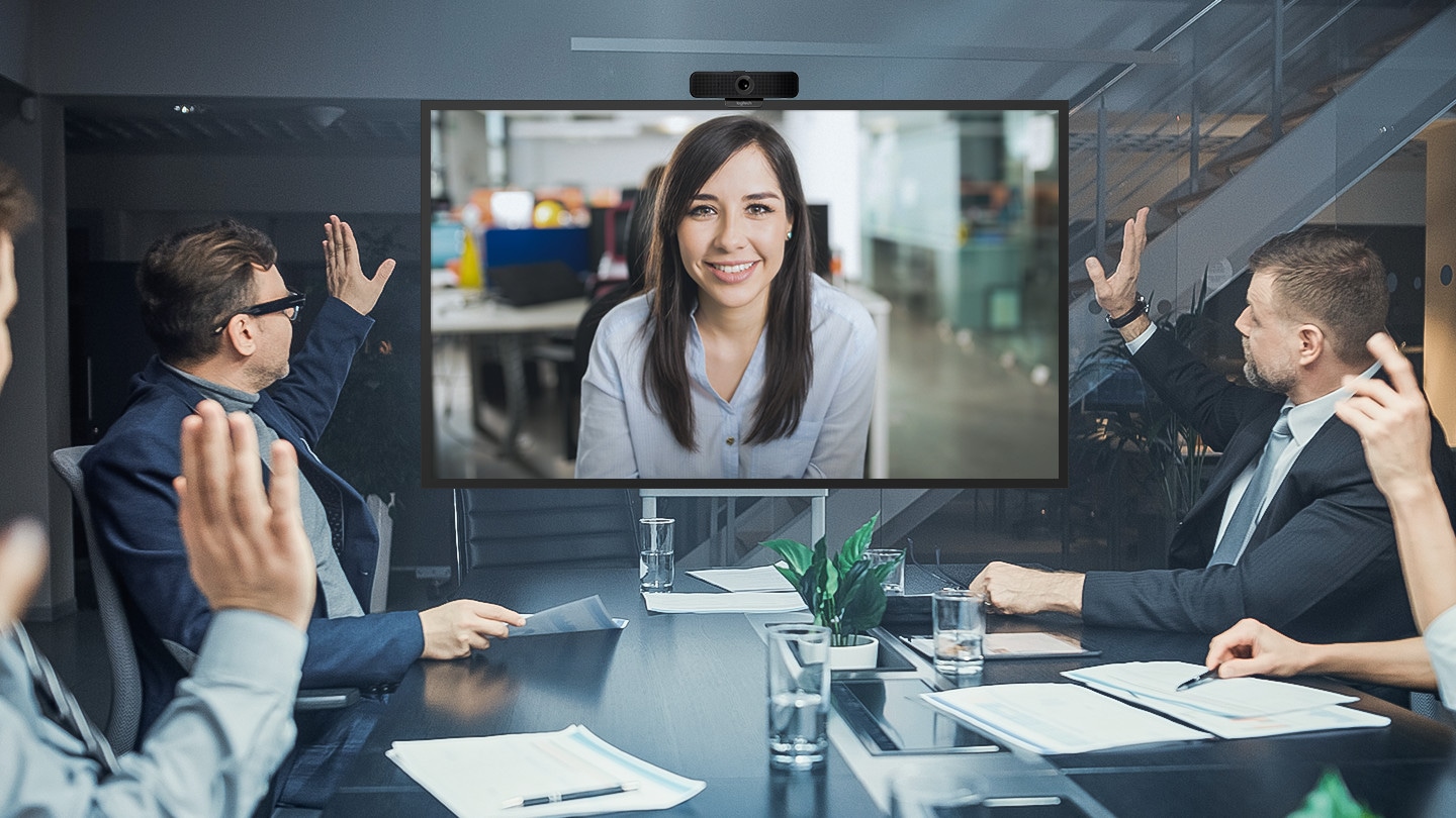 In the conference room, they greet each other while having a video conference through the video camera on the top of the QBB.