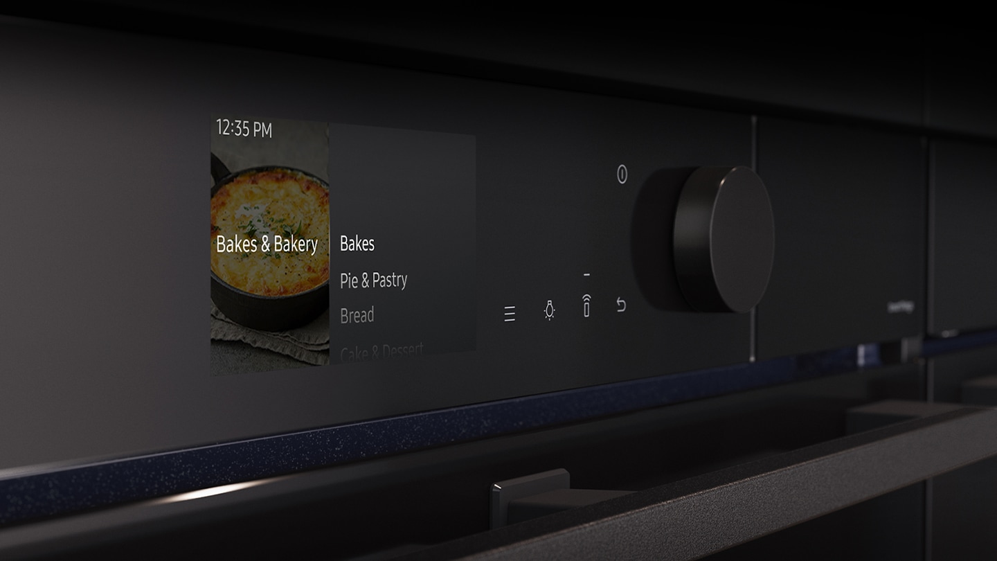 Shows a close-up of the oven's stylishly minimalist control panel with an LCD display, which shows pictures of the various cooking options, touch control and a single knob.