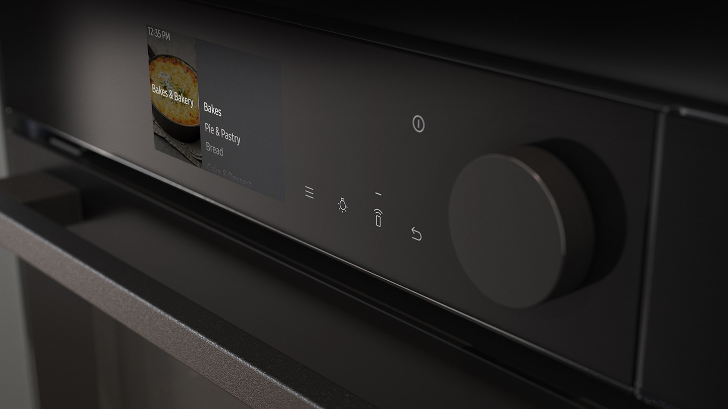 Shows a close-up of the oven's stylishly minimalist control panel with an LCD display, which shows pictures of the various cooking options, touch control and a single knob.