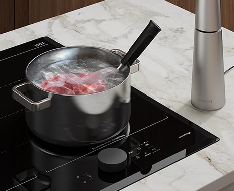 Sous-vide meat is cooked in a pot on the cooktop using an Assist Sensor.