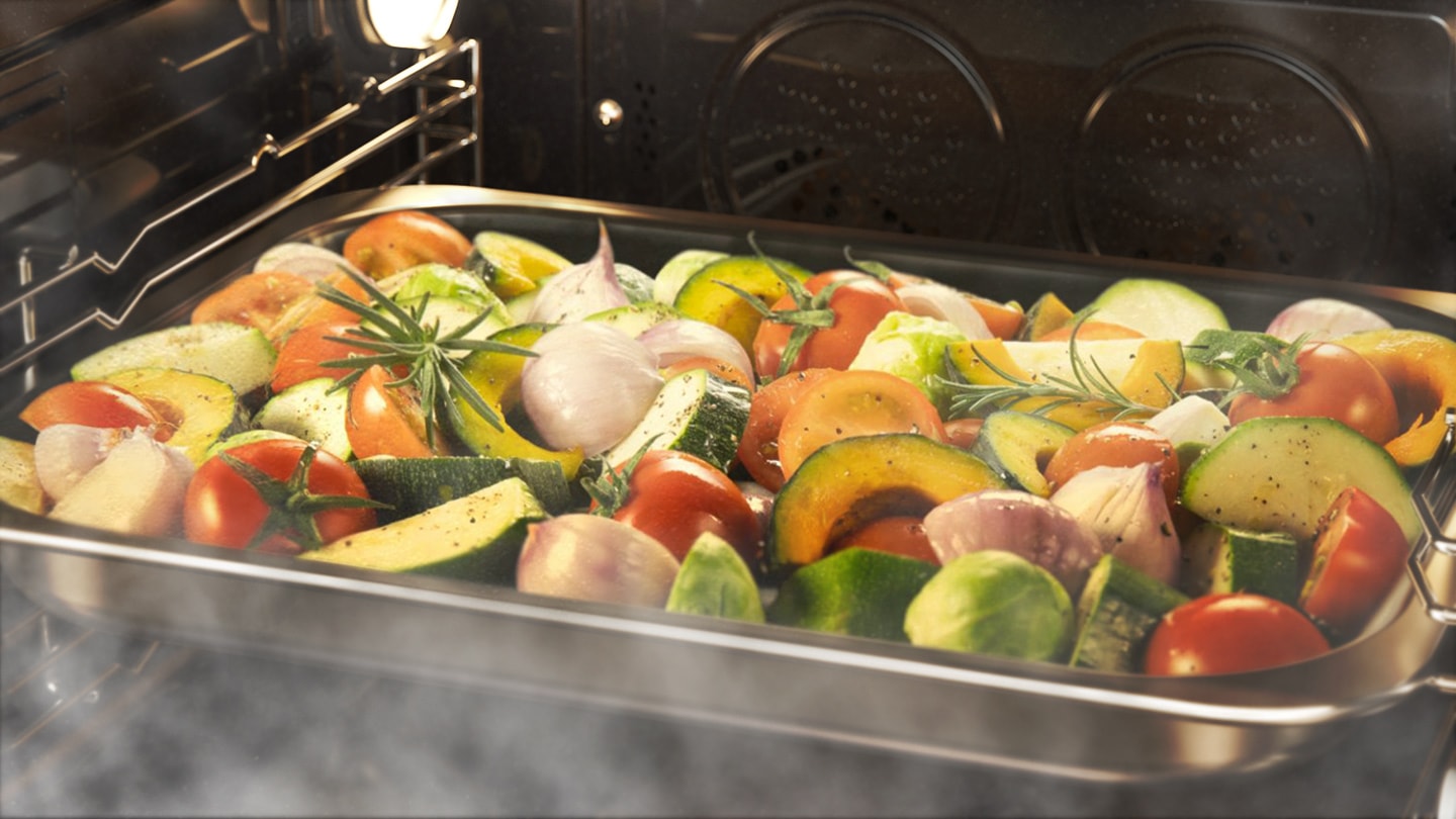 Shows a tray of mixed vegetables being steam cooked using the Full Steam option.