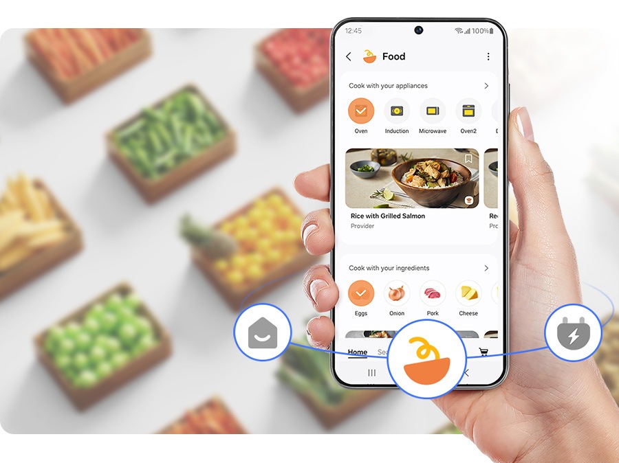 Egy személy a SmartThings mobilalkalmazást használja főzéshez.