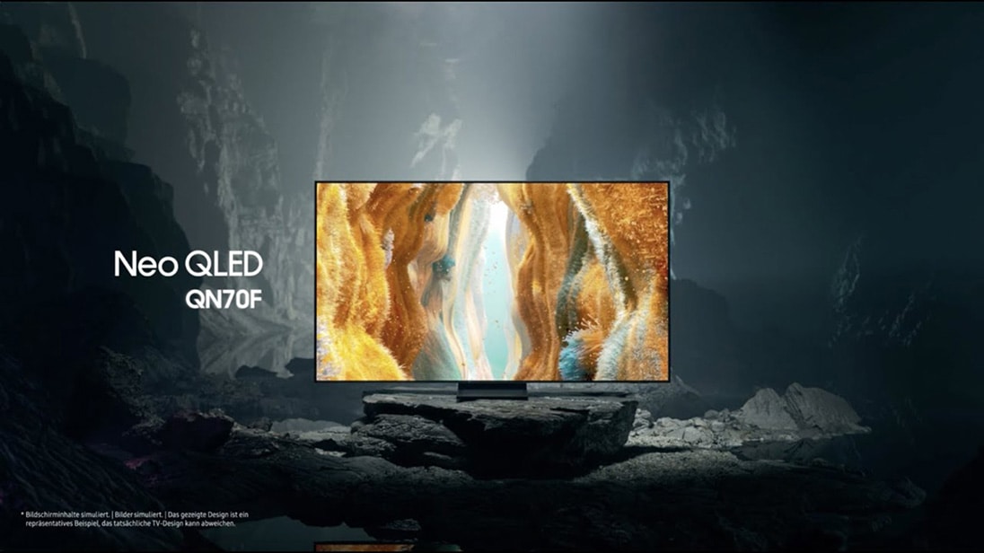 Der Samsung Neo QLED QN70F TV zeigt in einem schwarz-weißen unterirdischen Raum eine farbenfrohe Szene einer außerirdischen Landschaft.