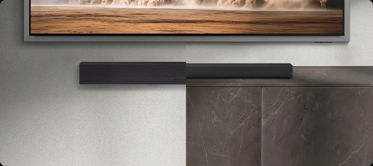 Two soundbars next to each other. One is mounted on a wall and one lies flat on a tabletop.