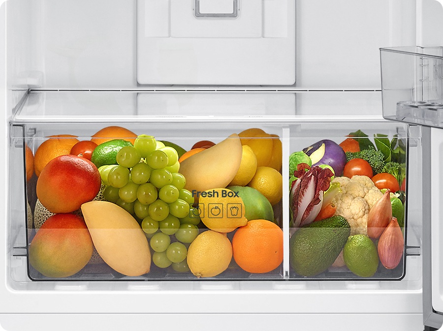 A lot of vegetables and fruits are stored in the veg box.