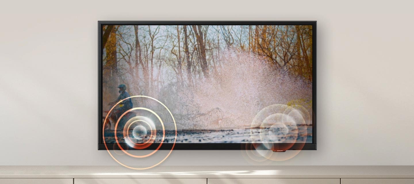 A person on a motorcycle is zipping past from one side to another. Built-in speakers follow the sound of the motorcycle as it moves.