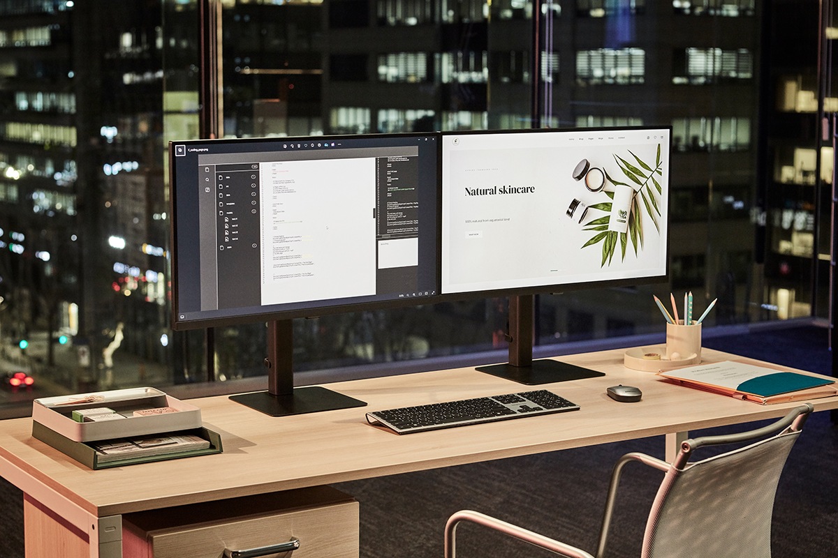 There are two ViewFInity monitors on a desk, and a document and a web browser are displayed on the monitor screens.