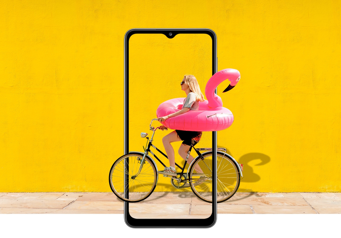 A woman on bike behind Galaxy A32 5G. The picture goes the phone display's edges to represent its immersive view.