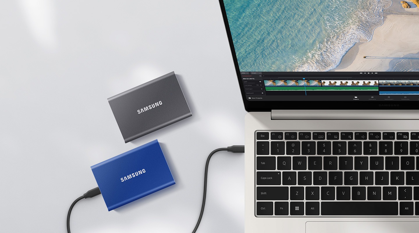 A laptop running a video editing program and two Samsung T7s are visible.