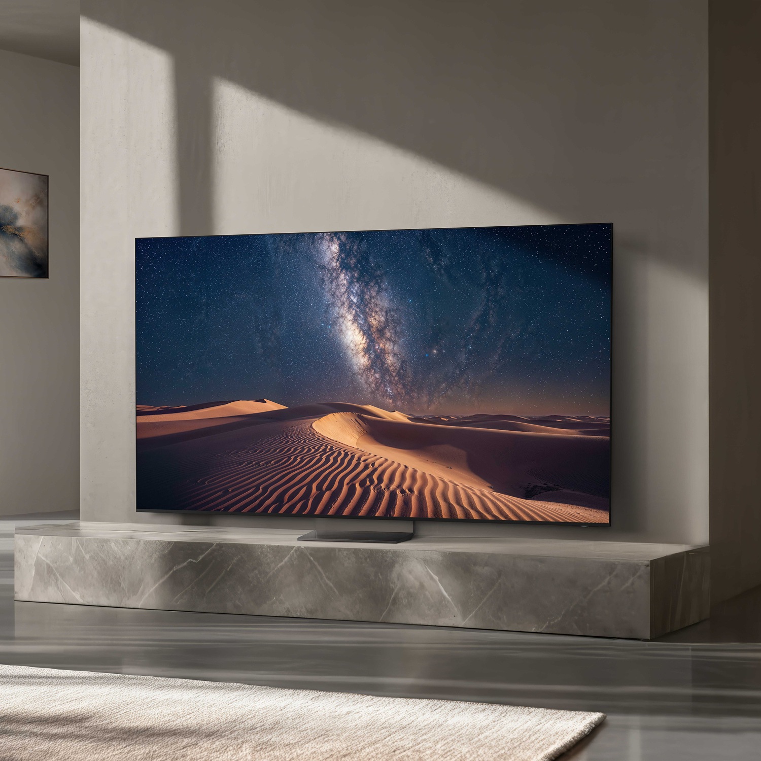 In a modern home setting, a large Samsung Micro RGB TV displays a beautiful desert landscape of sand dunes.