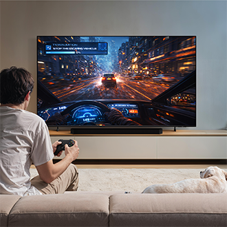 Person gaming on a Samsung Mini LED TV in a living room, racing through a neon-lit city with sharp detail, vivid colors, and smooth motion.