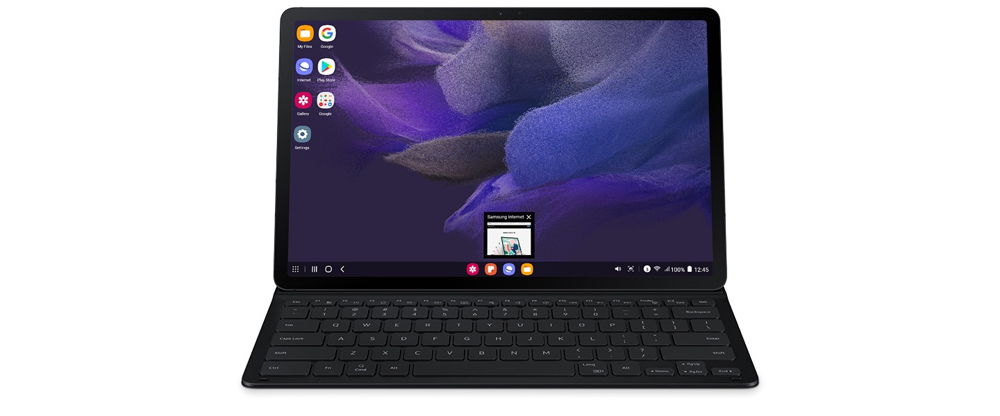 Galaxy Tab S7 FE with the Keyboard Cover installed. It is unfolded and the tablet has the Samsung DeX screen on its display. A thumbnail for Samsung Internet is seen.