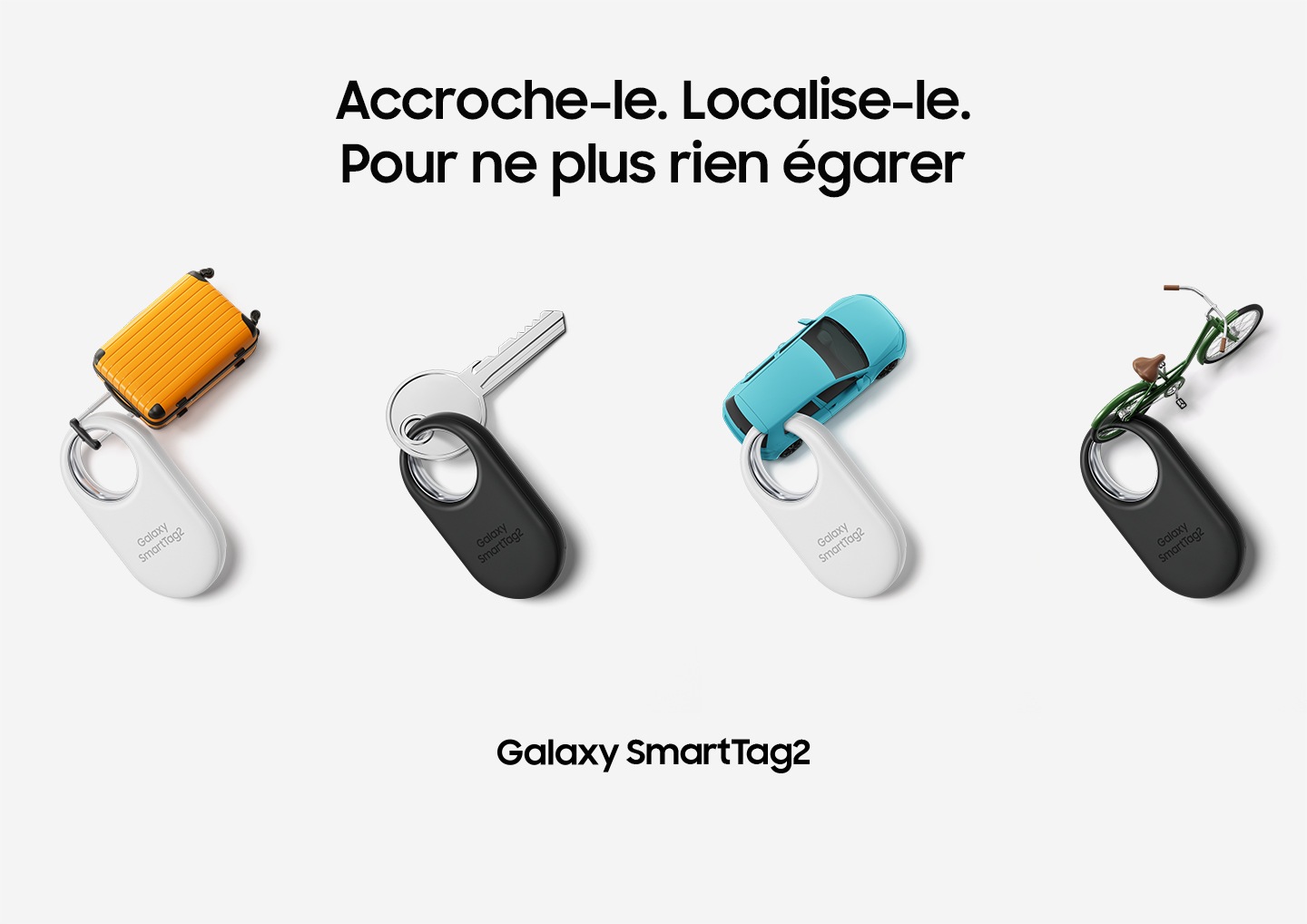 Four Galaxy SmartTag2 devices, two white and two black, are neatly placed. The devices are labeled with the following items: a miniature suitcase, a key, a miniature car, and a miniature bicycle.