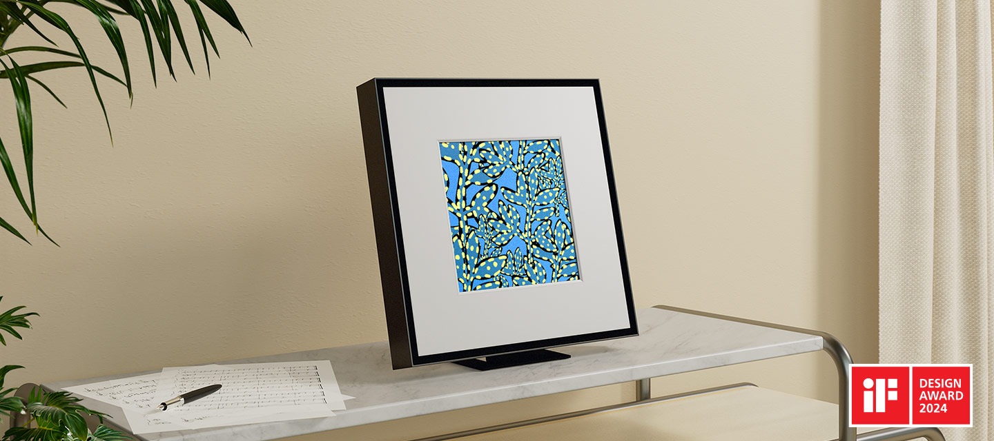 Music Frame displays an abstract blue vine pattern and is placed on top of a shelf. iF DESIGN AWARD 2024 logo.