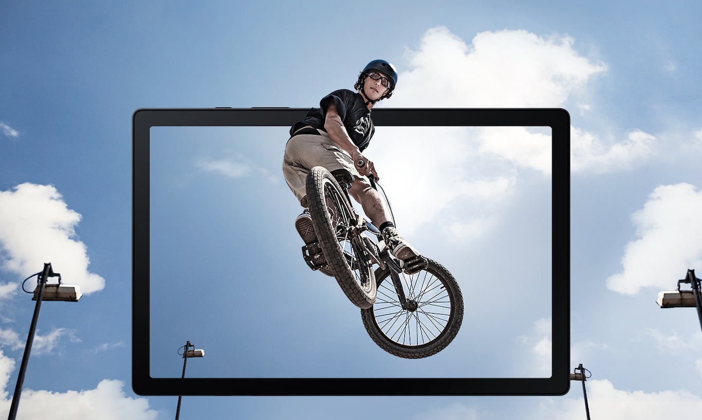 Un homme effectuant un saut en l'air sur un vélo BMX est montré en sortant de l'écran d'une tablette.