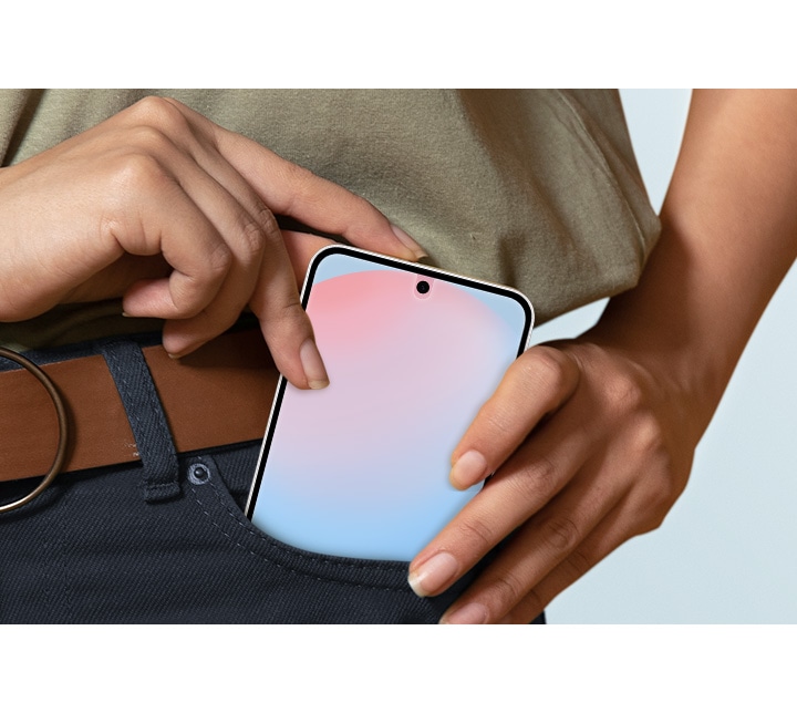 A hand is placing a Galaxy S24 FE with the Anti-Reflecting Film into a pants pocket.