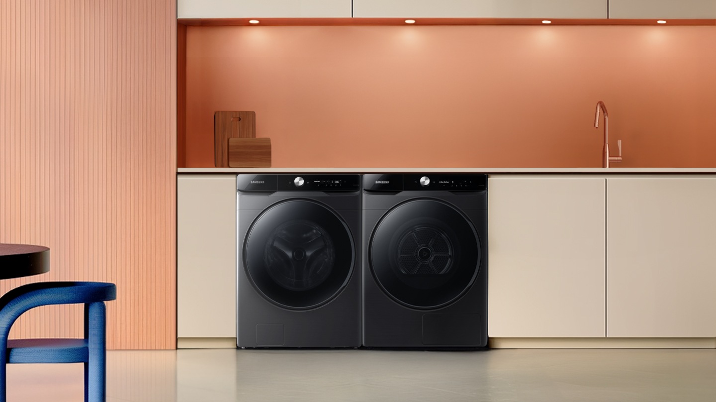 Intelligently efficient. The washing machine is installed with a dryer in a modern and minimalist laundry room.