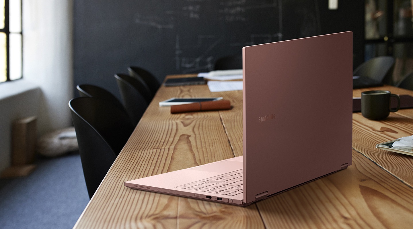 An opened Galaxy Book Flex2 placed on a table and it shows its super-solid Thin design and polished clear surfaces.