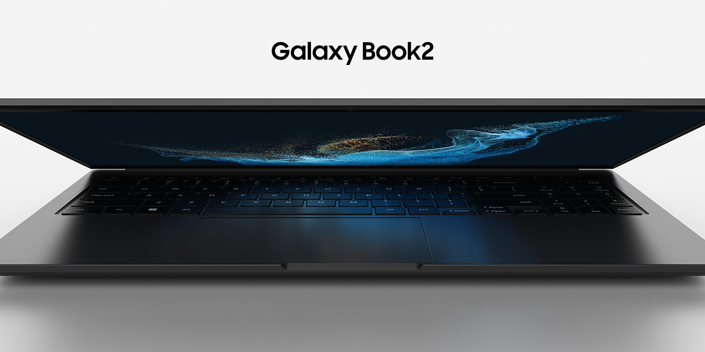 A slightly open graphite-colored Galaxy Book2 is facing forward with a wallpaper of blue waves.