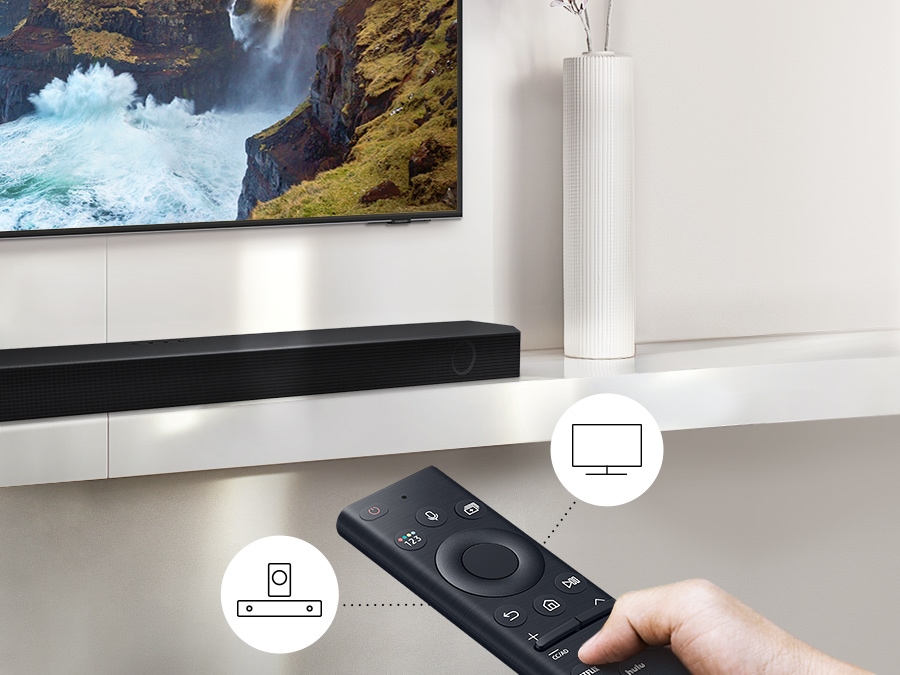 A user controls both soundbar and TV functions with Samsung TV remote.