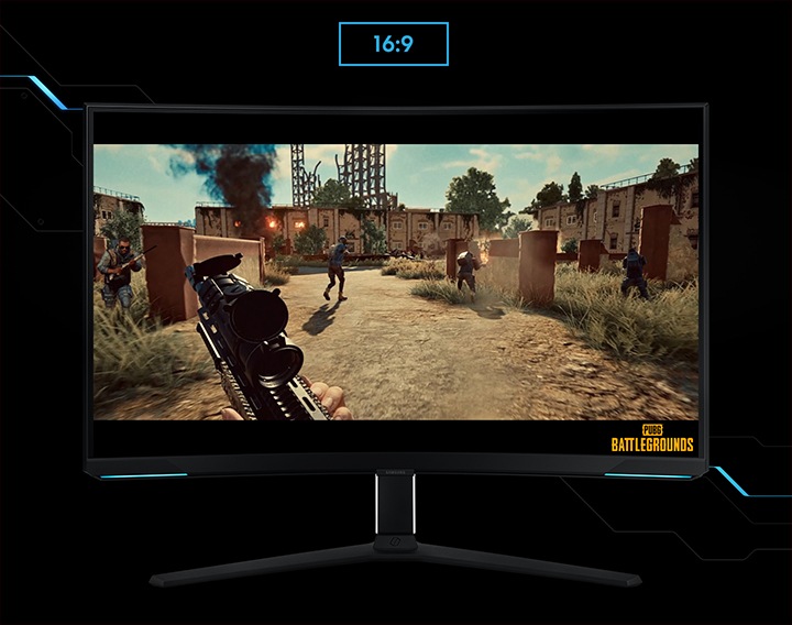 A monitor shows the viewpoint of a player within a shooting game. The player is running around a battle zone, with a machine gun. As the screen is extended from 16:9 to 21:9 proportion, an unseen enemy reveals in the left corner . "Battleground" logo is shown on the right lower corner of the screen.