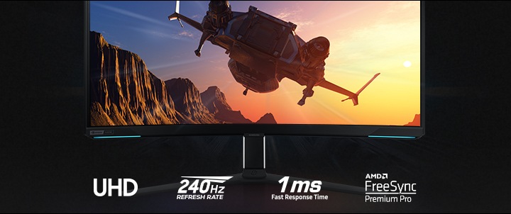 On the monitor display which is front facing, an aircraft is flying toward the sun over a mountain landscape. Underneath the stand of the monitor are four logos, demonstrating UHD resolution, 240Hz refresh rate, 1ms response time and NVIDIA G-SYNC compatibility.