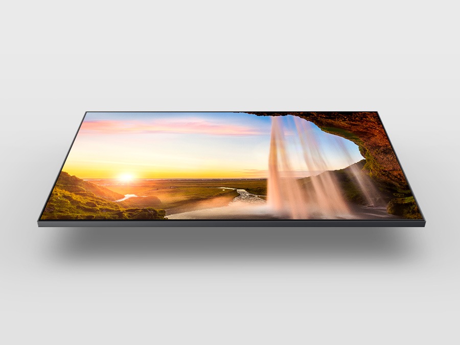 A QLED is displaying a sunset and a waterfall using the Dual LED backlight technology.