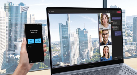 A hand turns the Galaxy S24 Ultra into a connected lens on the Galaxy Book4 Edge with a Microsoft Teams group video call window on the screen.