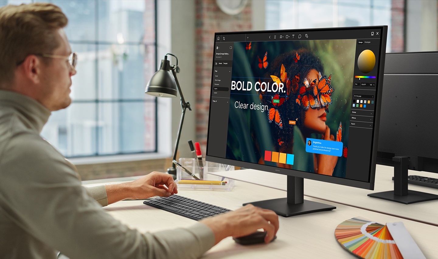 A person in an office is creating a design on a monitor.