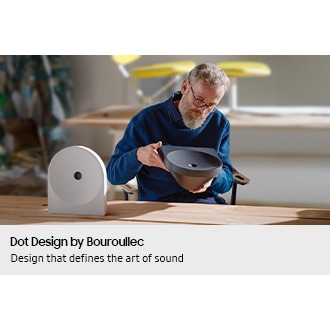 Designer Erwan Bouroullec examining the Dot form of Music Studio 5 speaker, illustrating the design process behind the sculptural sound concept.