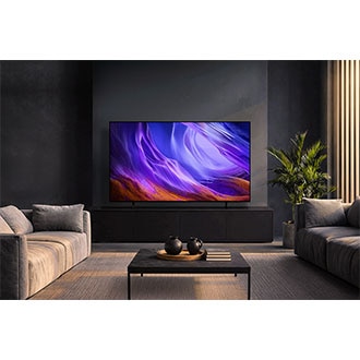 Samsung OLED TV displayed in a dark, modern living room, showing vivid purple abstract visuals that complement the refined interior design.