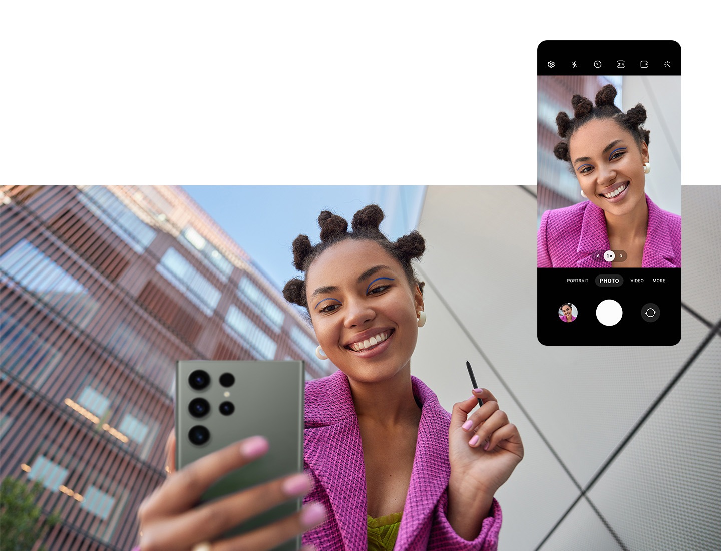 A woman standing outdoors between two buildings takes a selfie photo with the Front Camera of Galaxy S23 Ultra using the S Pen's Remote Control function. On top, the graphical user interface of the Camera application on Galaxy S23 Ultra is shown with the woman in the center.