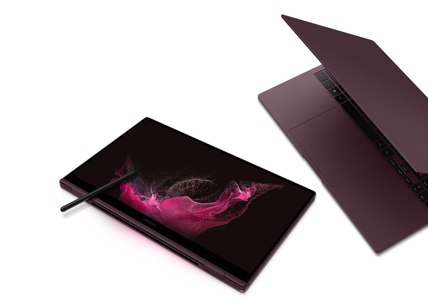 Two burgundy-colored Galaxy Book2 Pro 360 devices are next to each other. The one on the left is folded like a tablet and an S Pen is placed on the screen that has a pink wavy wallpaper. The one on the right is half open and is facing towards the Galaxy Book2 Pro 360 on the left.